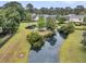 Aerial view of the backyard pond surrounded by lush landscaping and neighborhood homes at 2467 Bergeron Way, Mount Pleasant, SC 29466