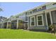 Exterior view of property featuring a shaded patio, green backyard, and privacy fence at 2648 Balena Dr, Mount Pleasant, SC 29466