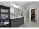 Well-lit bathroom featuring a gray vanity, marble countertop, and walk-in closet access at 2648 Balena Dr, Mount Pleasant, SC 29466
