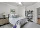 Cozy bedroom featuring calming colors, ceiling fan, decor shelves, and ensuite entrance at 2648 Balena Dr, Mount Pleasant, SC 29466