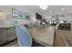 Dining area features wainscoting, decorative art and lighting, and natural wood floors at 2648 Balena Dr, Mount Pleasant, SC 29466