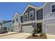Beautiful townhome exterior showcasing garages and charming architectural details, with both US and state flags displayed at 2648 Balena Dr, Mount Pleasant, SC 29466