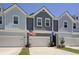 Charming townhome with a well-maintained exterior, multiple garages, and visible American and South Carolina flags at 2648 Balena Dr, Mount Pleasant, SC 29466