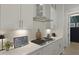 Modern kitchen features gas cooktop, herringbone backsplash, quartz counters and stainless steel range hood at 2648 Balena Dr, Mount Pleasant, SC 29466