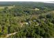 Aerial shot showing a cozy neighborhood bordered by a lush river and dense forestry at 2790 Burden Creek Rd, Johns Island, SC 29455