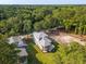 Aerial view highlighting the property with screened porch, landscaping, and surrounding greenery at 2790 Burden Creek Rd, Johns Island, SC 29455