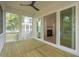 Covered back porch showcasing wood flooring, a ceiling fan and view into living room at 2790 Burden Creek Rd, Johns Island, SC 29455