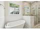 Bright bathroom features a freestanding tub with a walk-in shower and a large window at 2790 Burden Creek Rd, Johns Island, SC 29455