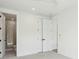 Bedroom showcasing adjacent bathroom, two closets, neutral carpet and a ceiling fan at 2790 Burden Creek Rd, Johns Island, SC 29455