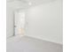 Bright bedroom featuring neutral carpet, white walls and view into a bedroom through the open door at 2790 Burden Creek Rd, Johns Island, SC 29455