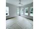 Bright bedroom featuring four large windows, white trim, and a modern ceiling fan at 2790 Burden Creek Rd, Johns Island, SC 29455