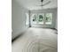 Bright bedroom featuring four large windows, white trim, and a modern ceiling fan at 2790 Burden Creek Rd, Johns Island, SC 29455