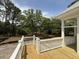 Covered deck with wood flooring overlooks a private wooded lot in this attractive home at 2790 Burden Creek Rd, Johns Island, SC 29455