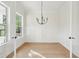 Bright dining room with wood floors, white walls, and a modern chandelier at 2790 Burden Creek Rd, Johns Island, SC 29455
