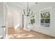Bright dining room with wood floors, paneling, and a modern chandelier at 2790 Burden Creek Rd, Johns Island, SC 29455