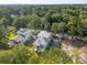 Eye-level aerial view of the home and its surrounding landscaped yard and tall tree coverage at 2790 Burden Creek Rd, Johns Island, SC 29455