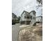 Two-story home with pale siding, elevated on pilings with gravel driveway at 2790 Burden Creek Rd, Johns Island, SC 29455