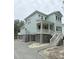 Charming, elevated two-story home featuring light blue siding and white trim accents at 2790 Burden Creek Rd, Johns Island, SC 29455