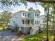Charming coastal home featuring a welcoming porch, white railings, and ample natural light at 2790 Burden Creek Rd, Johns Island, SC 29455