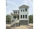 New two-story house with pale siding, elevated with stairs to front porch at 2790 Burden Creek Rd, Johns Island, SC 29455