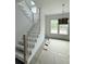 Entryway with staircase, hardwood floors, and a modern light fixture, offering a stylish welcome at 2790 Burden Creek Rd, Johns Island, SC 29455