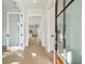 Bright foyer featuring wood floors, white trim, and a view of the kitchen at 2790 Burden Creek Rd, Johns Island, SC 29455