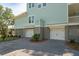 A spacious two-car garage featuring white doors, and complimented by lush landscaping at 2790 Burden Creek Rd, Johns Island, SC 29455