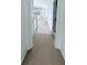Hallway leading to kitchen, with white doors and trim at 2790 Burden Creek Rd, Johns Island, SC 29455