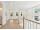 Upstairs landing with natural light, hardwood floors, and views, a perfect spot for relaxation at 2790 Burden Creek Rd, Johns Island, SC 29455