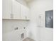 Bright laundry room features white cabinets at 2790 Burden Creek Rd, Johns Island, SC 29455