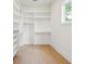 Bright walk-in closet with adjustable white shelving and drawers for optimal storage and organization at 2790 Burden Creek Rd, Johns Island, SC 29455