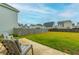 Spacious backyard with lush green lawn, privacy fence, and patio seating for outdoor enjoyment at 297 Red Leaf Blvd, Moncks Corner, SC 29461