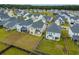 Aerial view of the backyard featuring plenty of green space, bordered by a wooden fence at 297 Red Leaf Blvd, Moncks Corner, SC 29461