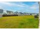 Expansive backyard featuring green grass, wood fencing, and scenic neighborhood views at 297 Red Leaf Blvd, Moncks Corner, SC 29461