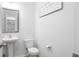 Bathroom with a pedestal sink, white toilet, decorative mirror, and inspirational wall art at 297 Red Leaf Blvd, Moncks Corner, SC 29461