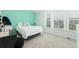 Bright bedroom with ample natural light, neutral carpet, white walls, and a cheerful mint accent wall at 297 Red Leaf Blvd, Moncks Corner, SC 29461