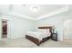 Neutral bedroom with a tray ceiling, plush carpet, and ensuite bath and closet entrances at 297 Red Leaf Blvd, Moncks Corner, SC 29461