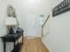 Inviting entryway with wood floors, stylish decor, and a view of the staircase and front door at 297 Red Leaf Blvd, Moncks Corner, SC 29461
