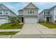 Charming two-story home with manicured lawn, inviting entrance, and a two-car garage at 297 Red Leaf Blvd, Moncks Corner, SC 29461