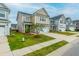 Inviting two-story home with manicured lawn, complemented by a tree-lined street and neat landscaping at 297 Red Leaf Blvd, Moncks Corner, SC 29461