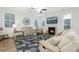 Cozy living room featuring a fireplace, comfortable seating, and bright natural light at 297 Red Leaf Blvd, Moncks Corner, SC 29461
