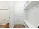 Bright mudroom with white accents, storage shelves, bench, coat hooks, and wood-look flooring at 297 Red Leaf Blvd, Moncks Corner, SC 29461