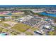 Aerial view showcasing a shopping center with multiple stores, parking, and surrounding natural landscape at 341 Witch Hazel St, Summerville, SC 29486