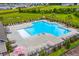 Aerial view of the community pool and lounge area, featuring a secure fence and lush landscaping at 341 Witch Hazel St, Summerville, SC 29486