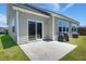 Backyard patio with a grill, sliding glass doors to the home, and green grass at 341 Witch Hazel St, Summerville, SC 29486