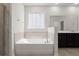 Bathroom featuring a soaking tub and vanity with dark wood cabinetry at 341 Witch Hazel St, Summerville, SC 29486