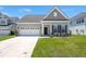 Charming single-Gathering home with a two-car garage and well-maintained lawn, creating curb appeal at 341 Witch Hazel St, Summerville, SC 29486