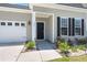 Inviting home exterior showcasing a two-car garage, manicured lawn, and charming front entryway at 341 Witch Hazel St, Summerville, SC 29486