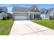 A well-kept single-Gathering home with a two-car garage, a tidy lawn, and tasteful landscaping at 341 Witch Hazel St, Summerville, SC 29486