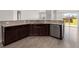 Open kitchen featuring stainless dishwasher and granite countertops with dark wood cabinetry at 341 Witch Hazel St, Summerville, SC 29486